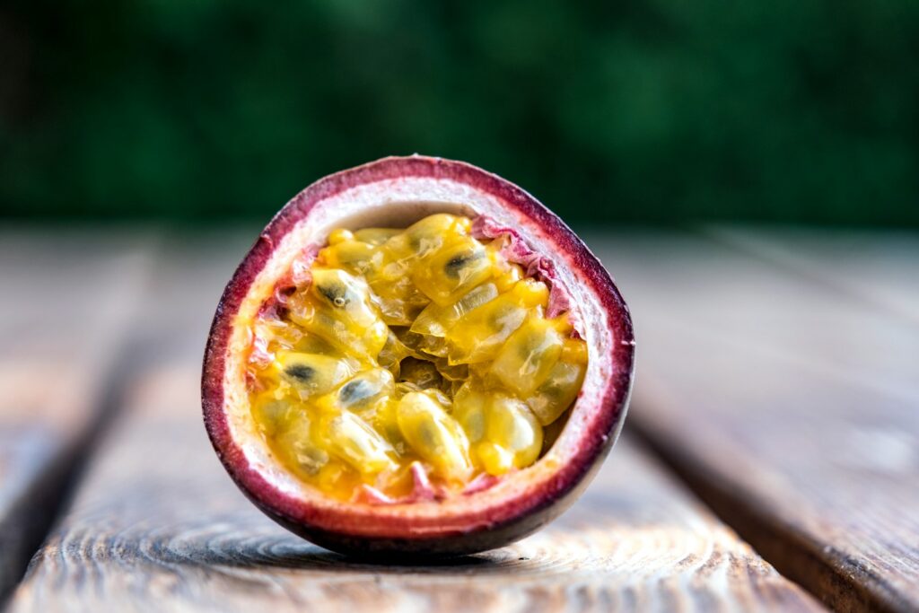 red and yellow round fruit on brown wooden table